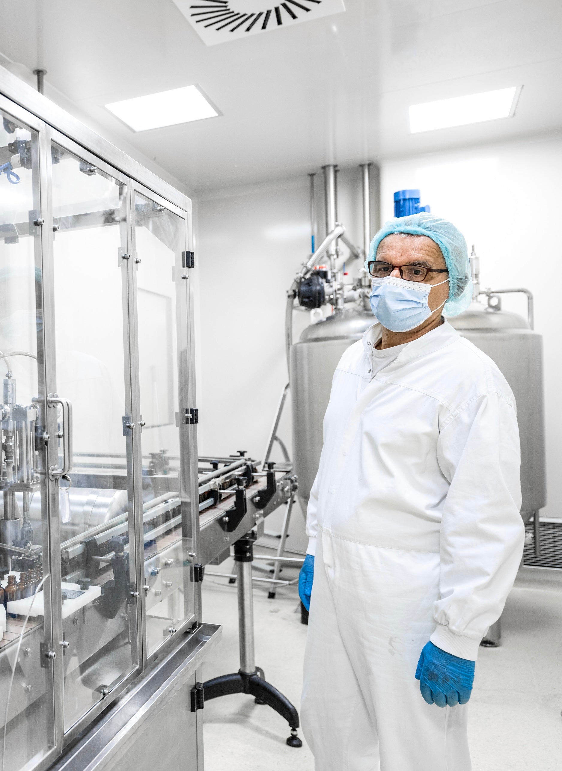Man in lab overalls working in a nutritional lab.