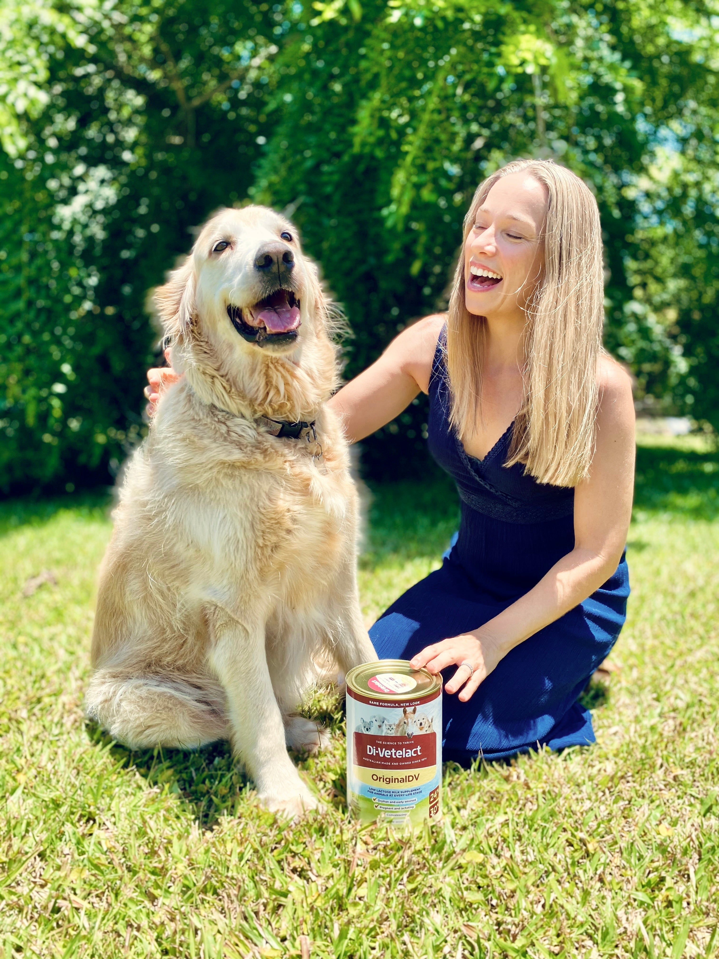 Dog and woman happy with 900g can of Di-Vetelact milk supplement for animals.
